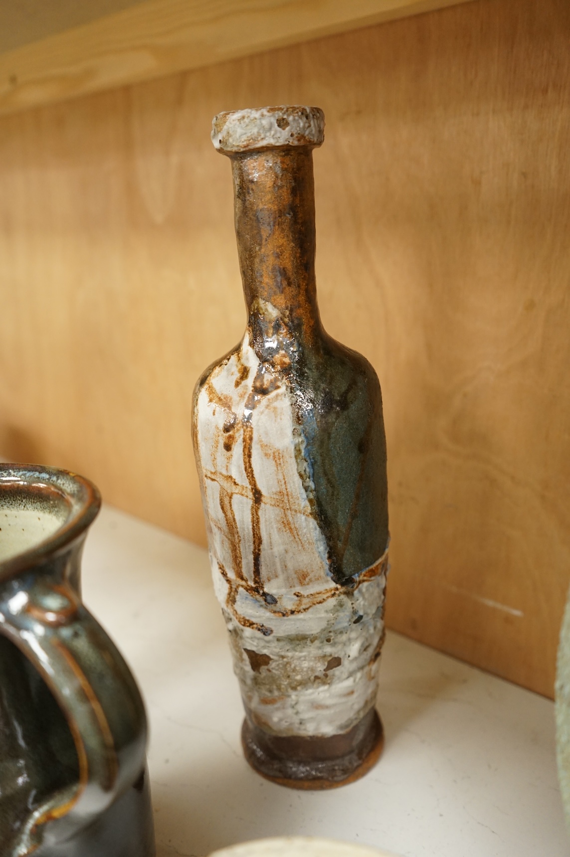 A group of eleven pieces of mixed 1960's-80's pottery to include vases, jugs and two rectangular dishes, largest 34cm high